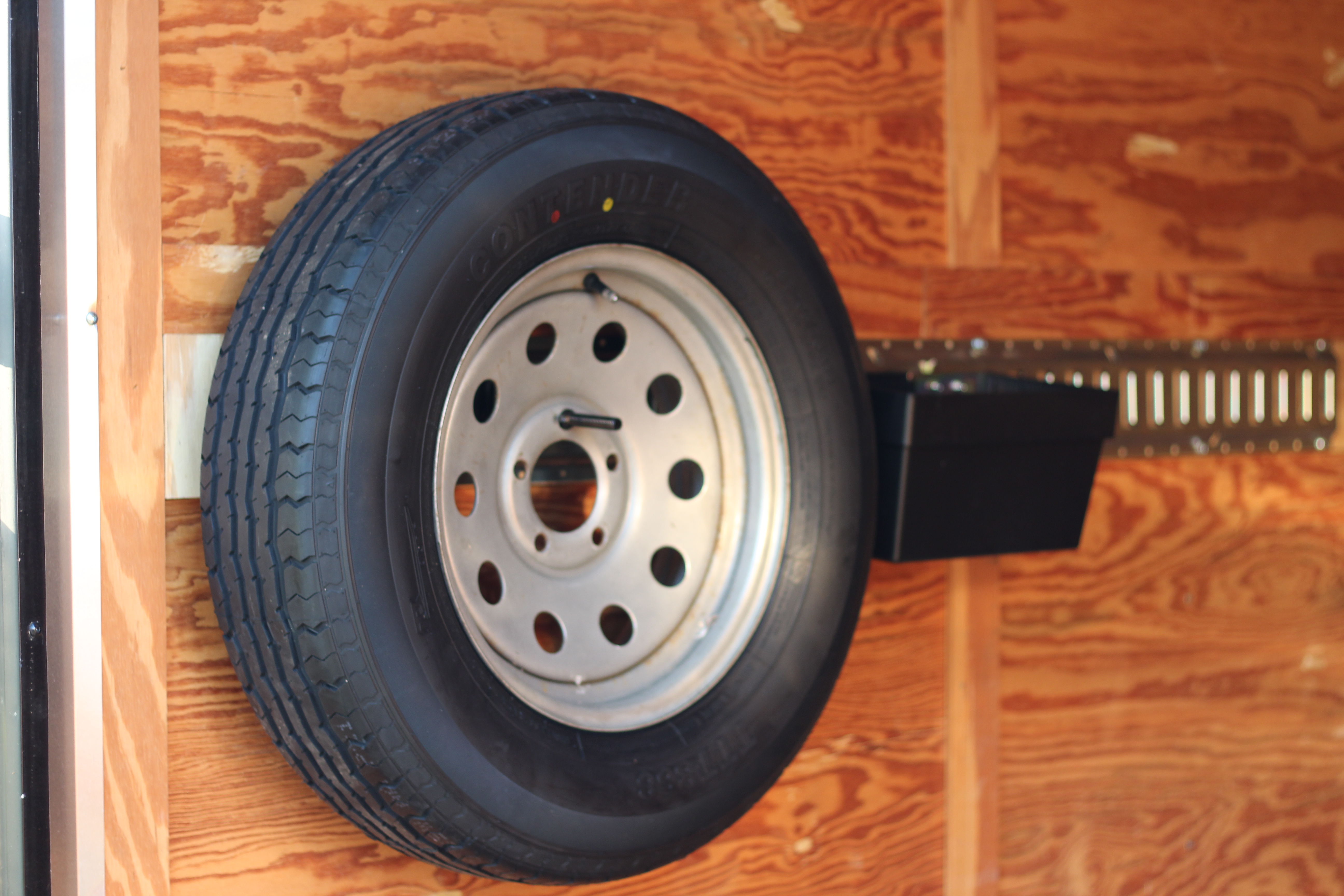 6x12 SA001 — wall-mounted spare tire inside cargo area